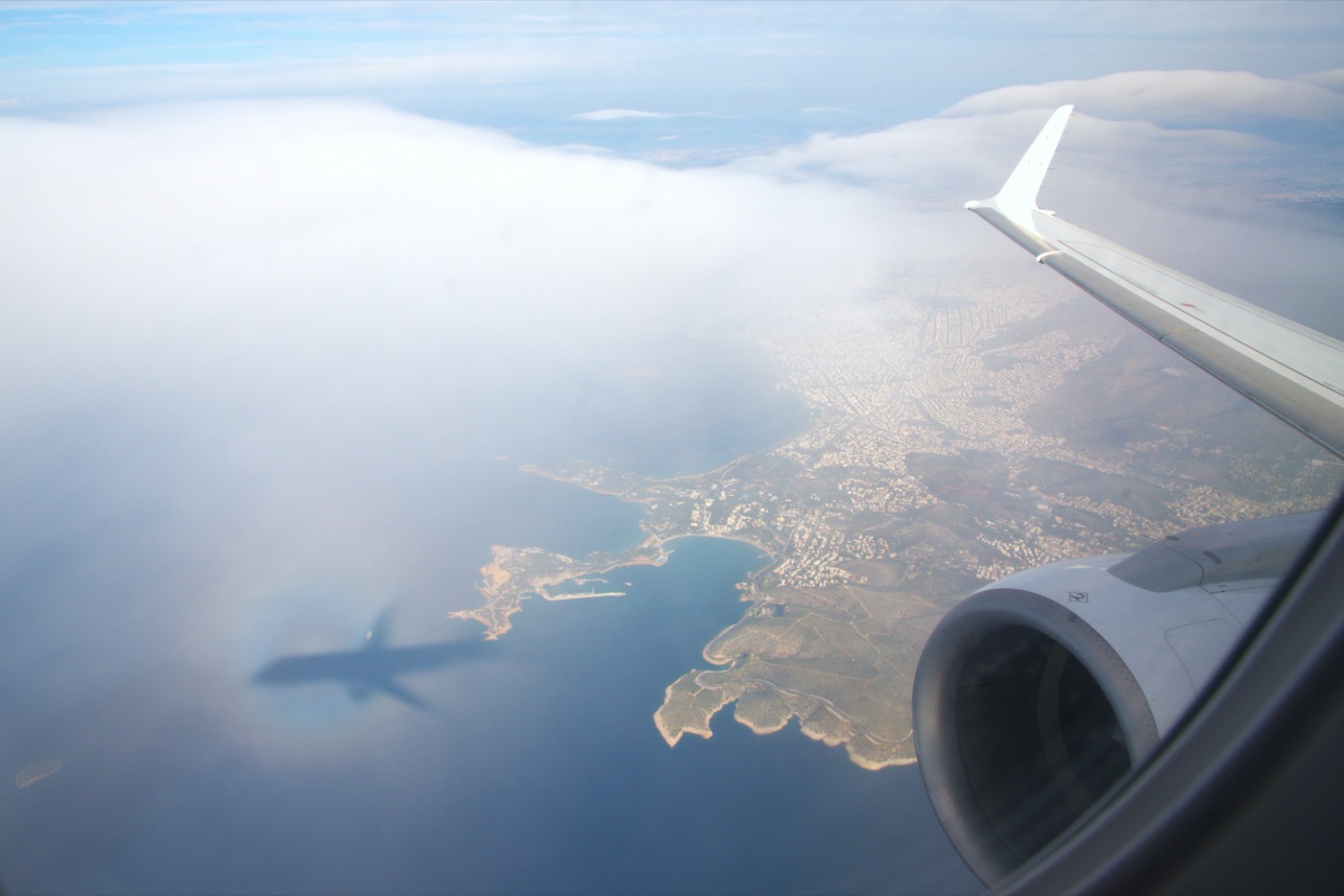 View from a Marathon Airlines cabin window over a coastline, the wing and engine in frame