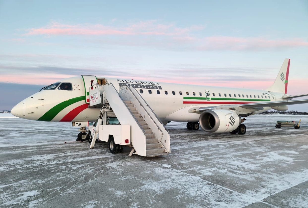 Embraer aircraft with Silversea Expeditions branding parked on a snow-covered apron